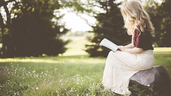 Girl with a book in the garden